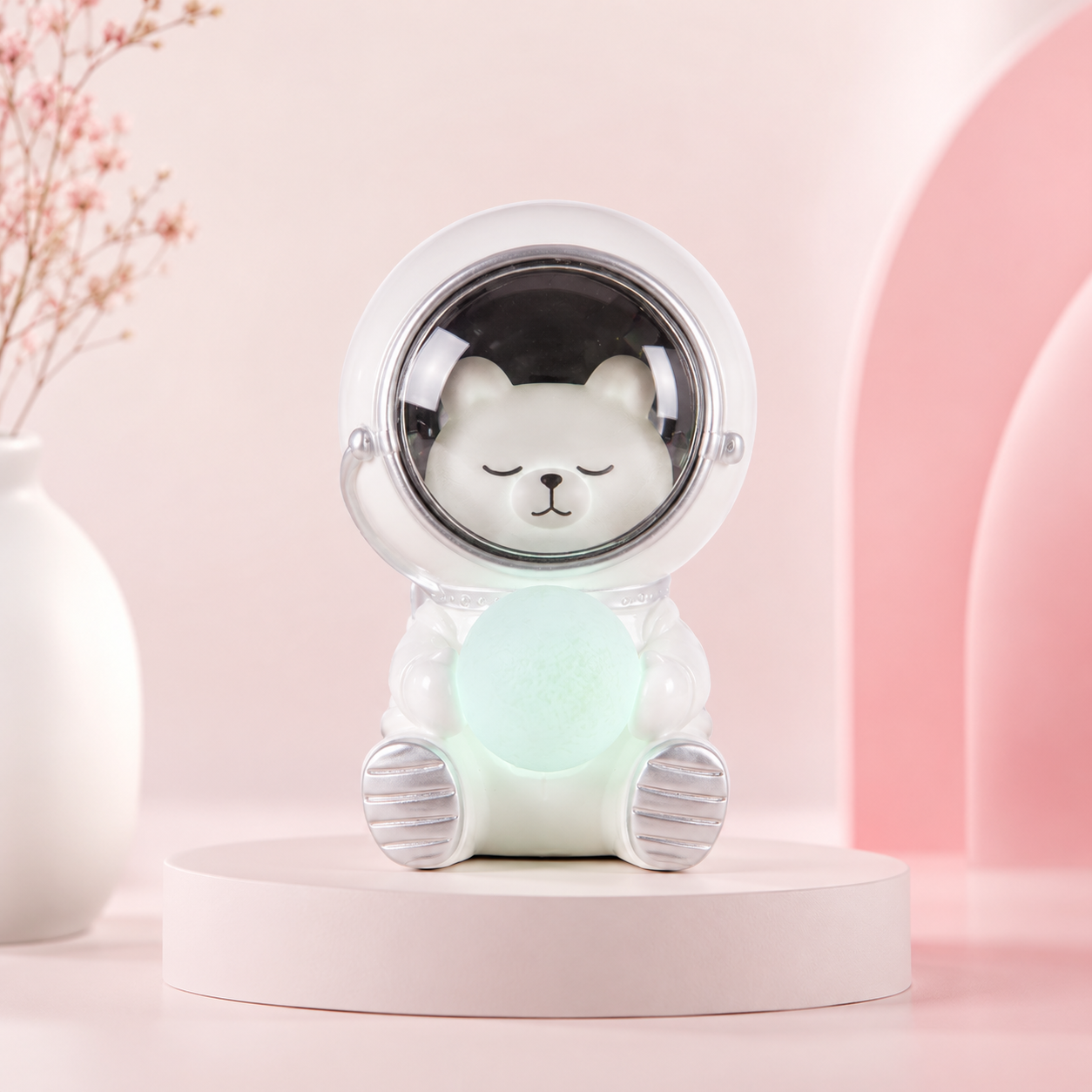 Small rechargeable character night light glowing warm white on a shelf.