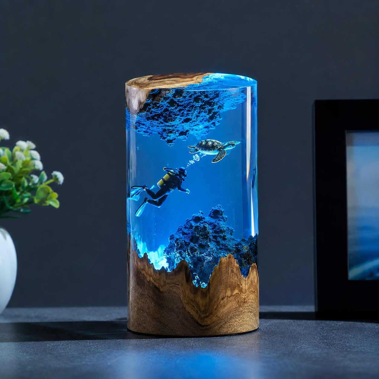 Underwater turtle scene suspended inside the illuminated resin cylinder.