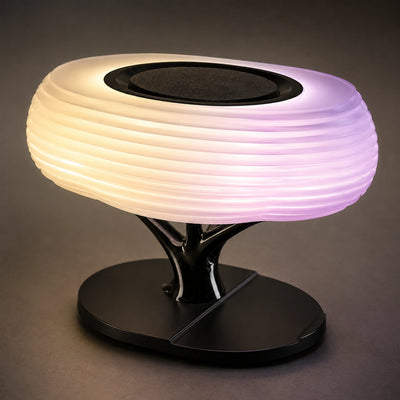 RGB tabletop lamp with an integrated wireless phone charging area.
