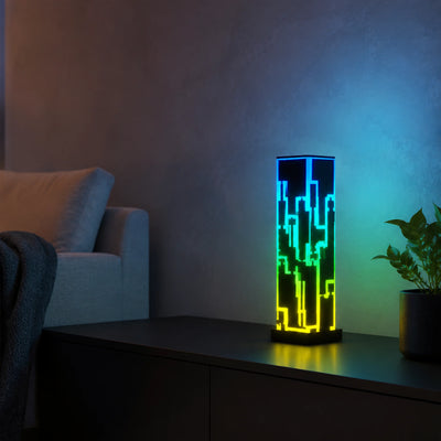Long geometric acrylic table lamp positioned on a media console.